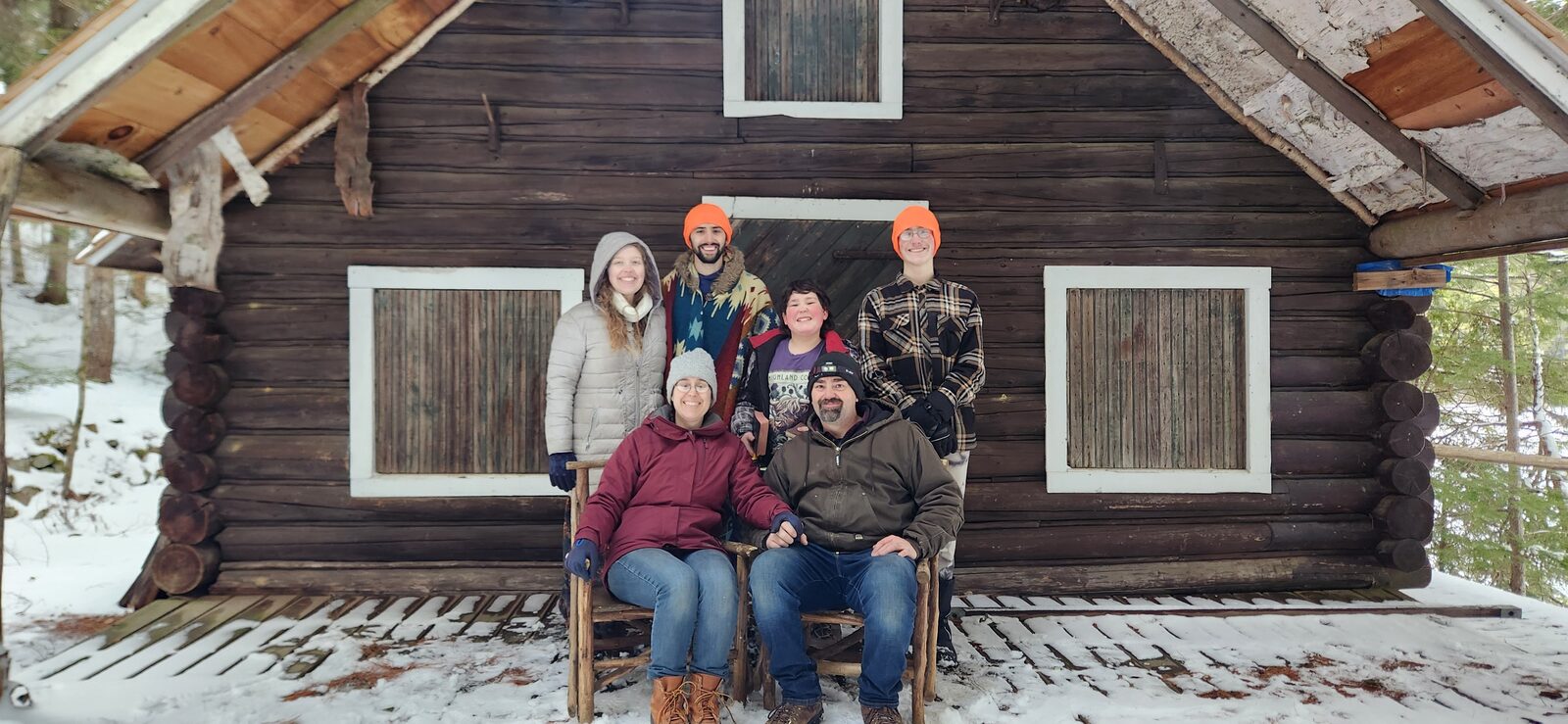 The family in front of the lodge at Craig Pond Wilderness Lodge
