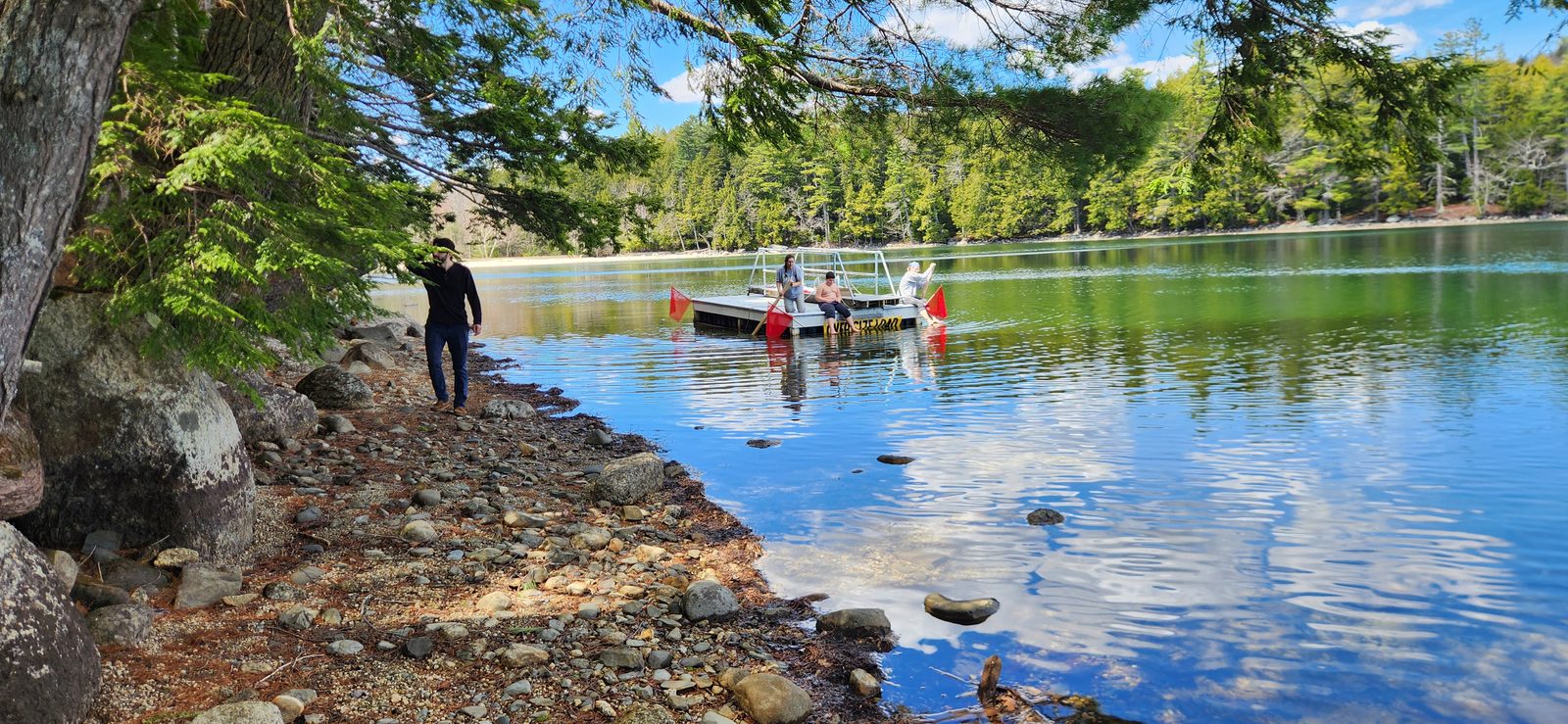 Boat and dock on the water at Craig Pond, Maine