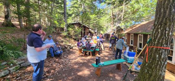 A gathering at the picnic tables between the cabins