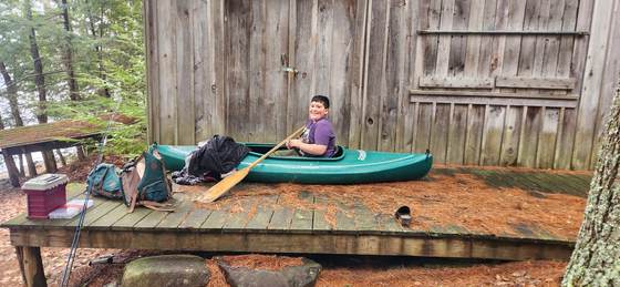 A young paddler setting off from the dock