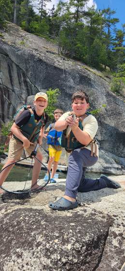 A fresh catch, perched on a granite ledge above the pond