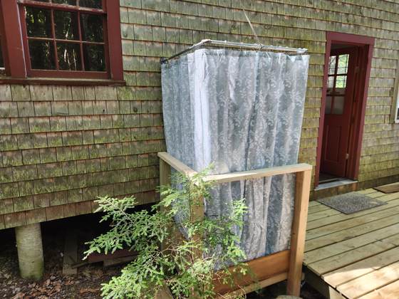 The outdoor shower on the side of a cabin