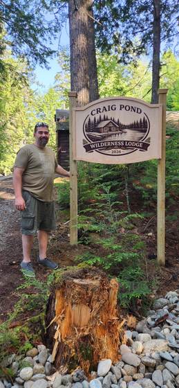 The Craig Pond Wilderness Lodge sign at the top of the road