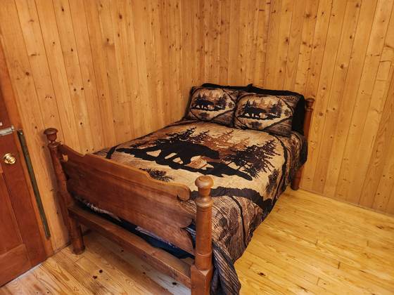 A pine-panelled bedroom in one of the cabins