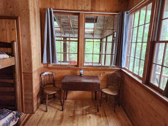 A writing table under the windows of a cabin