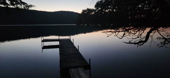 The dock silhouetted at last light on Craig Pond
